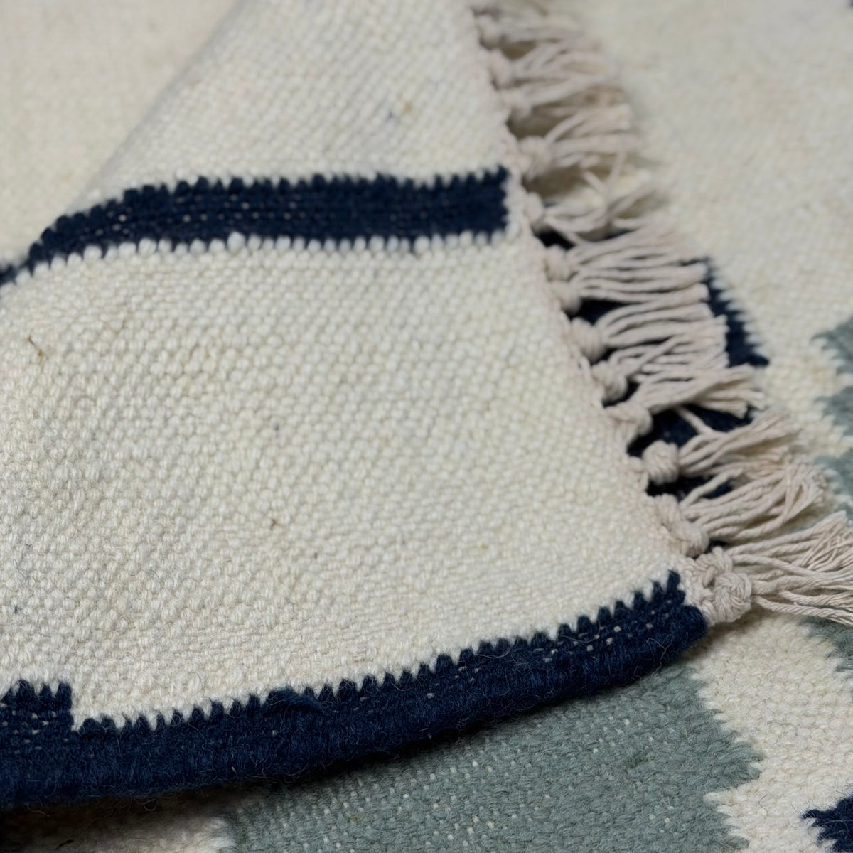 Close-up of a patterned rug with blue and white colors.