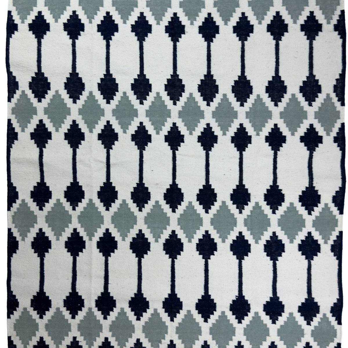 Patterned rug with geometric design on a white background