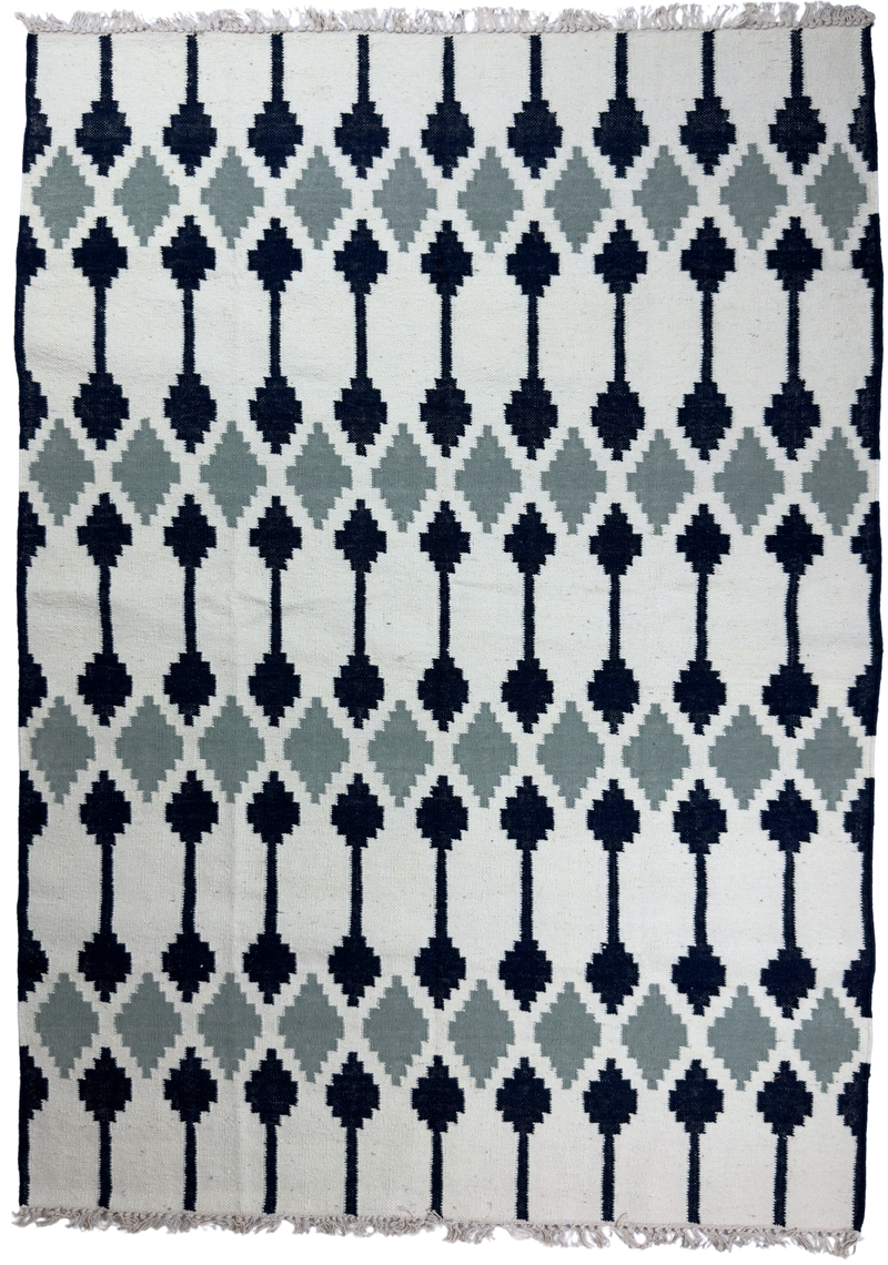 Patterned rug with geometric design on a white background