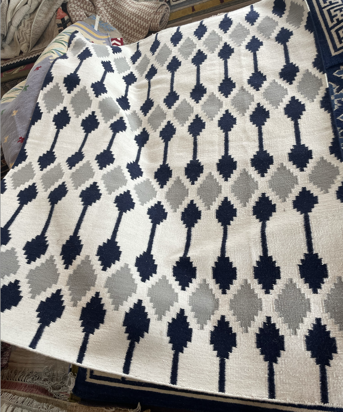 Patterned Rug with black and gray design on a surface