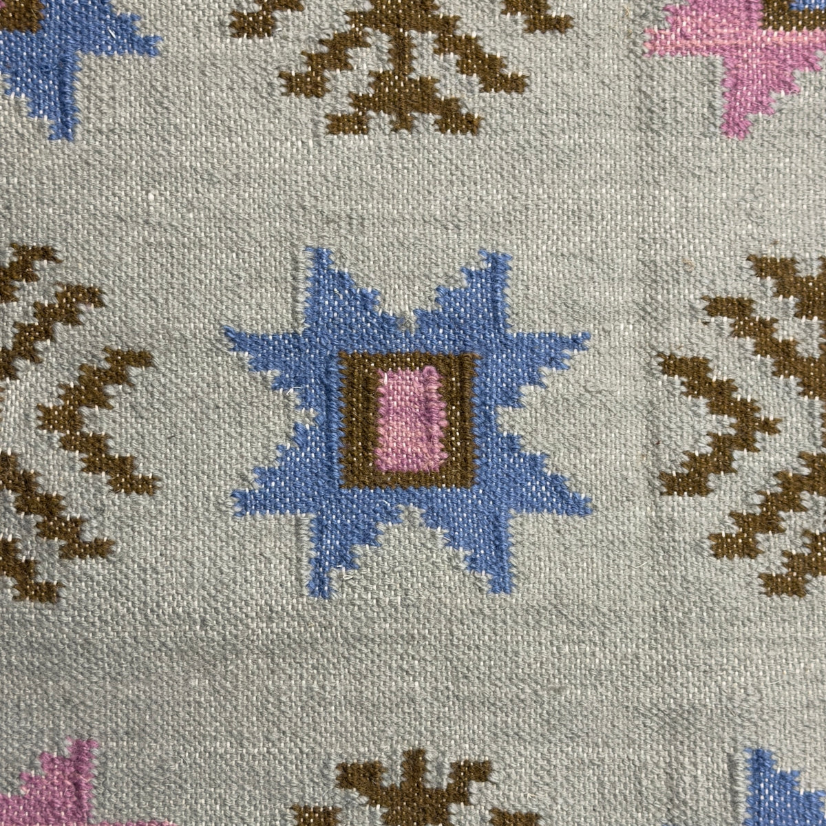 Patterned rug with geometric designs on a gray background