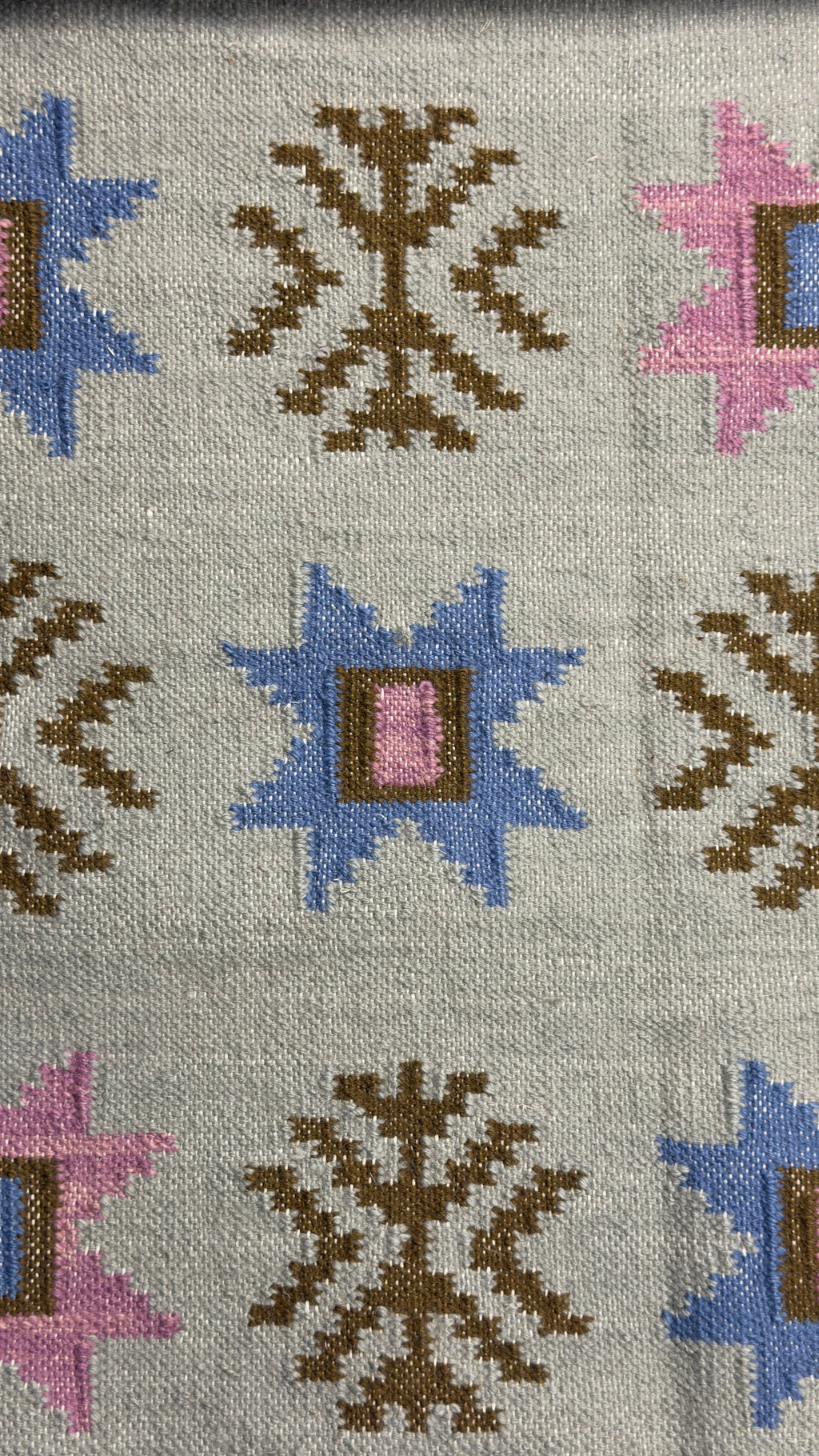 Patterned rug with geometric designs on a gray background