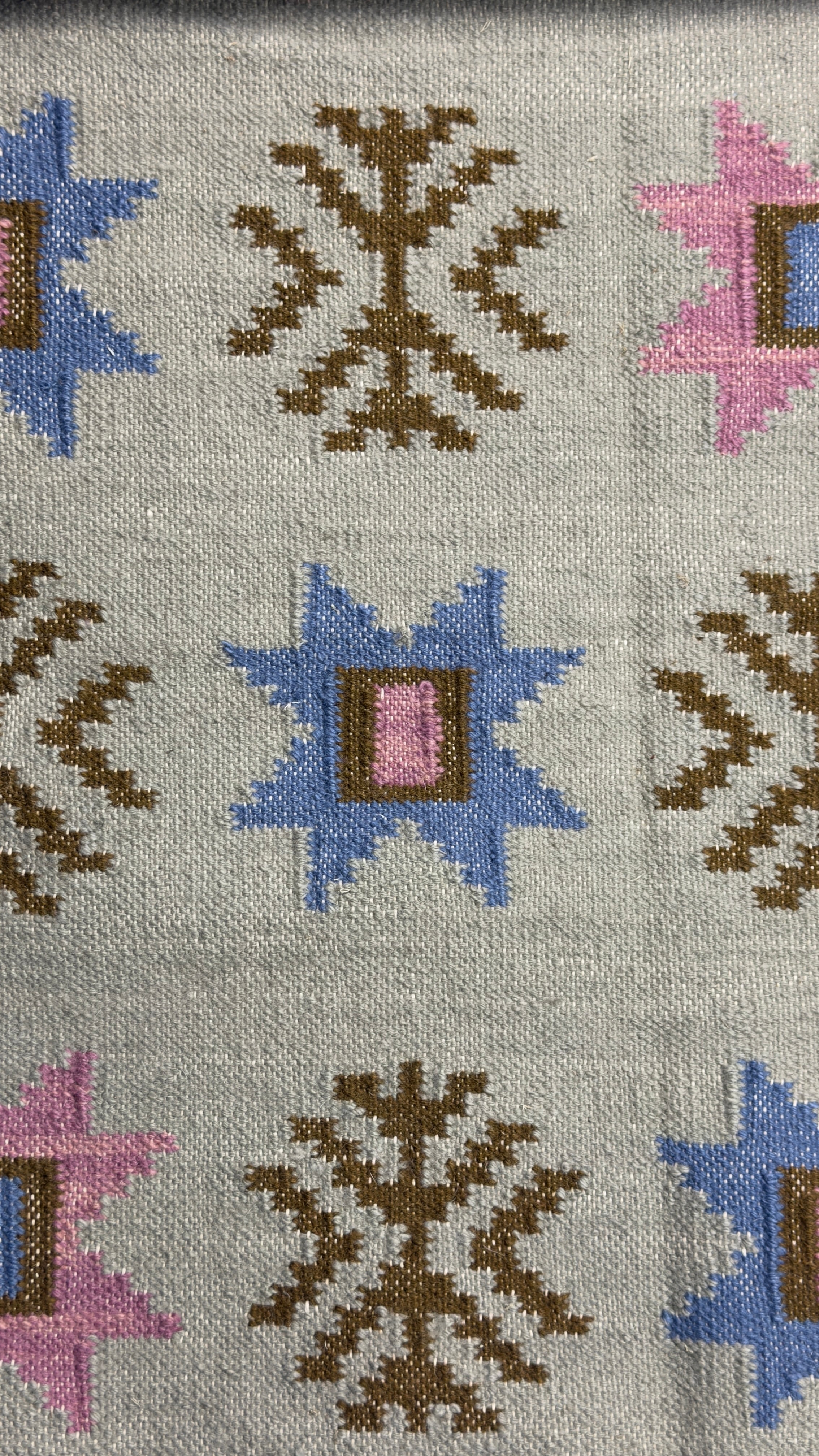 Patterned rug with geometric designs on a gray background