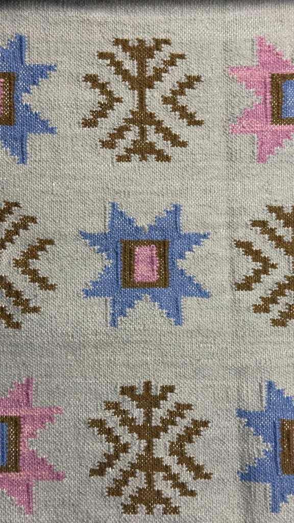 Patterned rug with geometric designs on a gray background