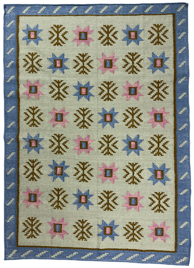 Rug with geometric pattern featuring blue, pink, and brown colors on a beige background.