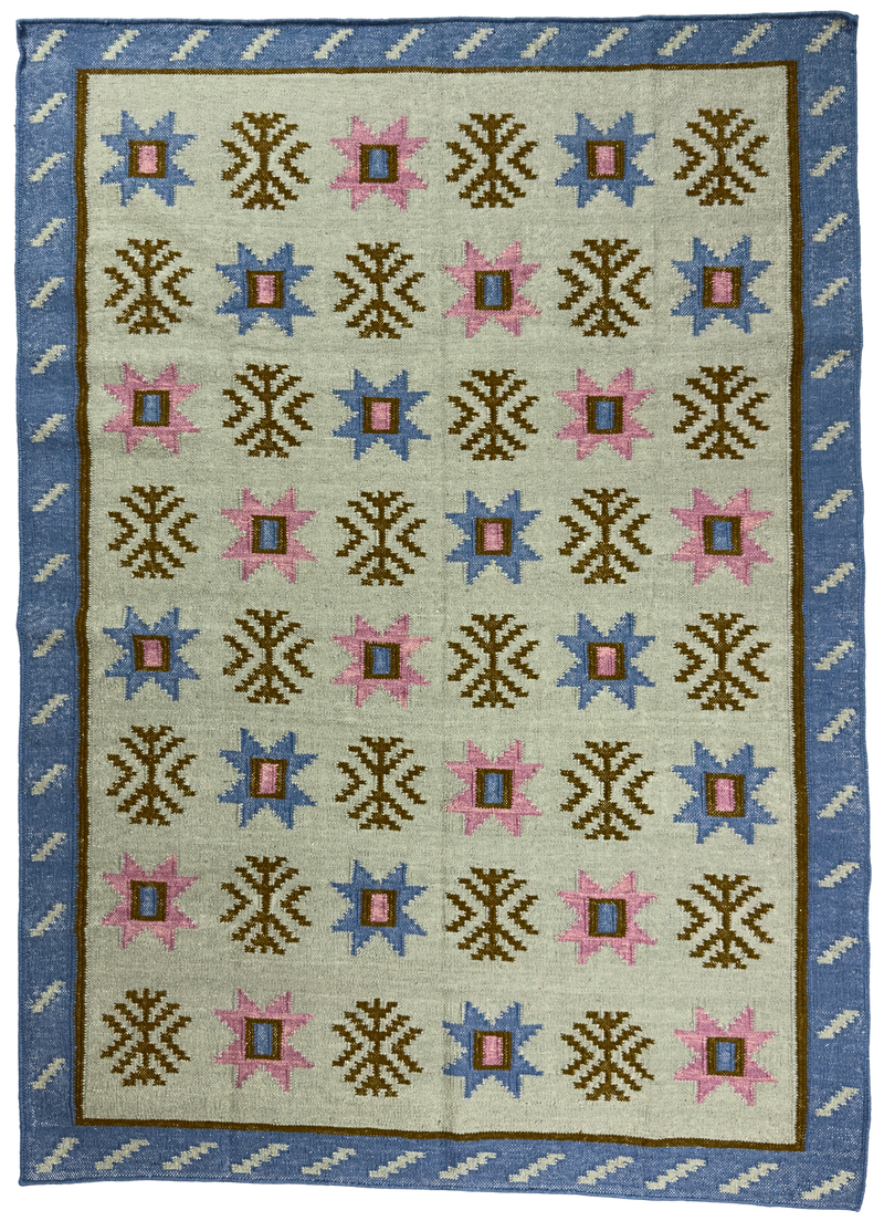 Rug with geometric pattern featuring blue, pink, and brown colors on a beige background.