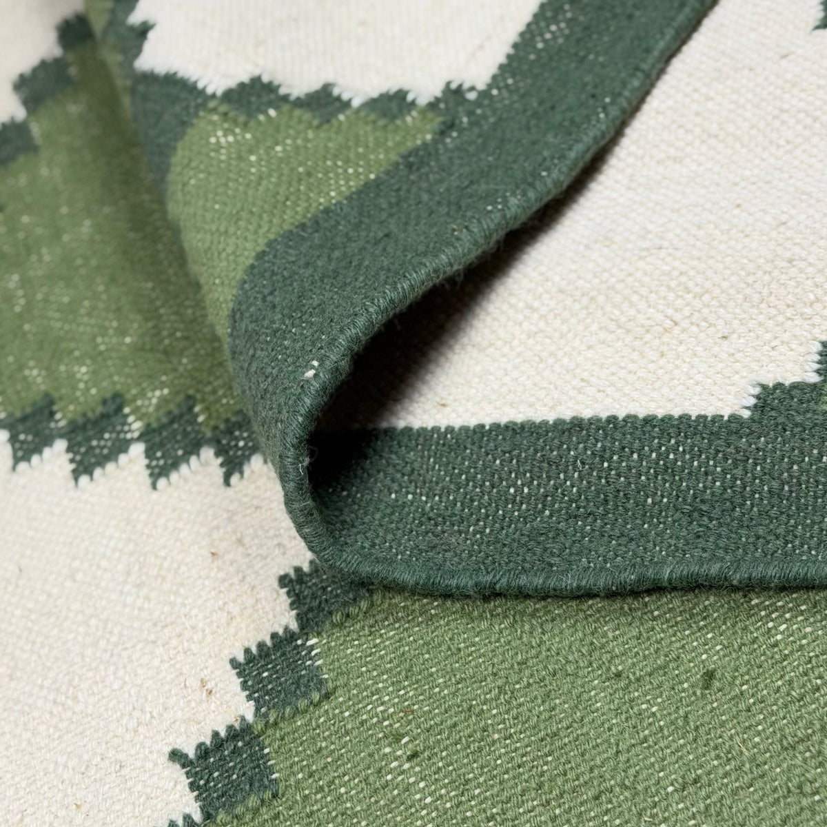 Close-up of a green and white patterned rug