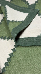 Close-up of a green and white patterned rug