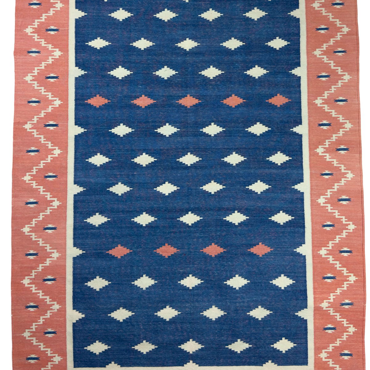 Rug with geometric pattern featuring blue, pink, and white colors