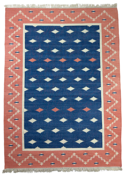Rug with geometric pattern featuring blue, pink, and white colors
