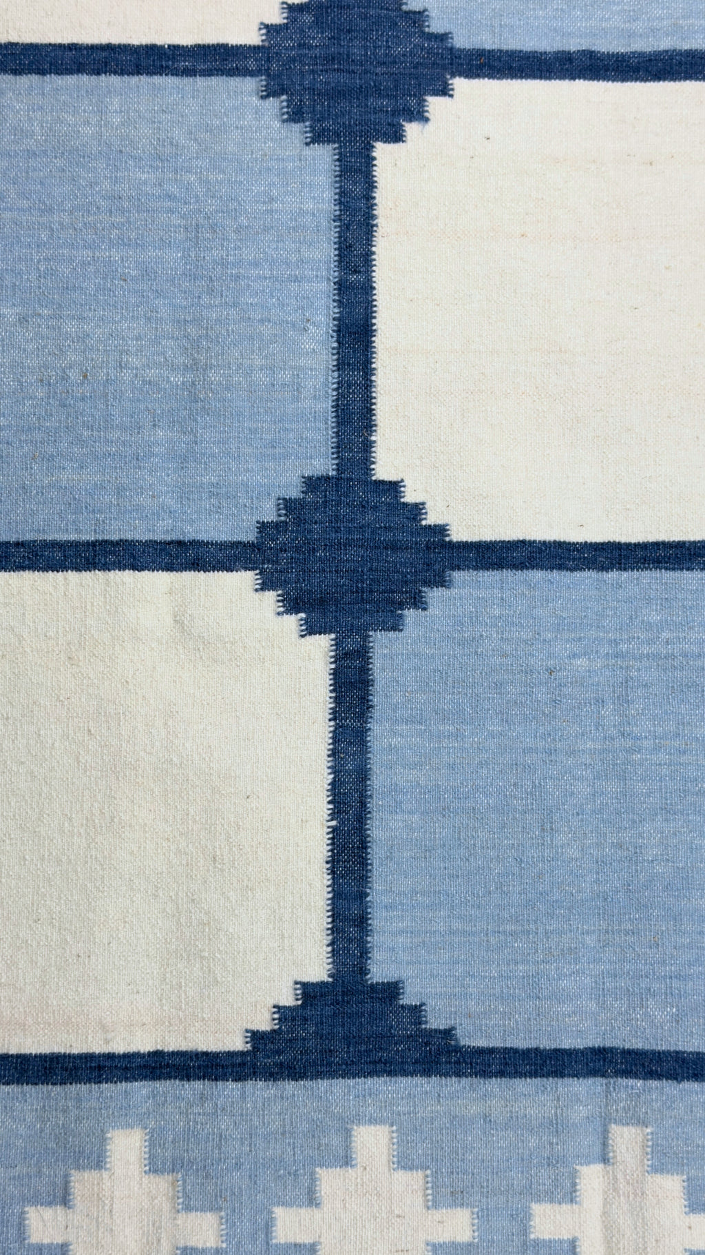 Close-up of a patterned rug with blue and white design