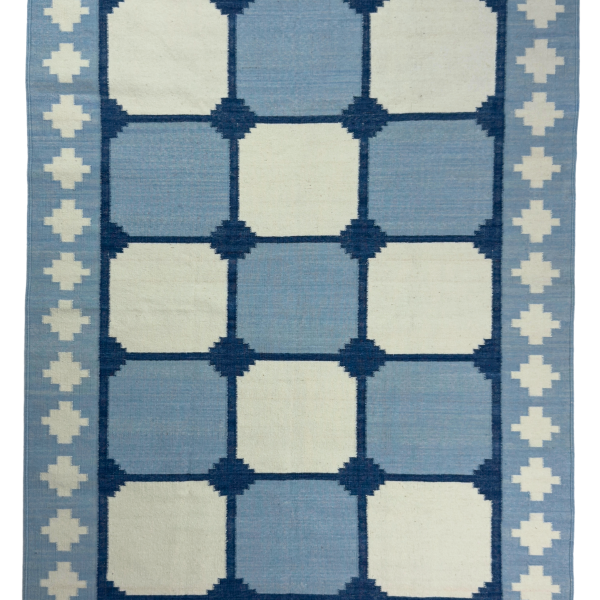 Blue and white geometric patterned rug with decorative border