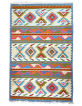 Colorful patterned rug with geometric design on a off white background